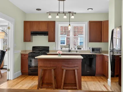a kitchen with stainless steel appliances a sink stove and refrigerator