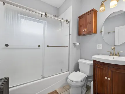 a bathroom with a toilet sink and shower