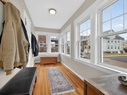 a living room with a rug and a couch