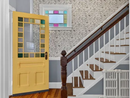 a view of front door of house with stairs