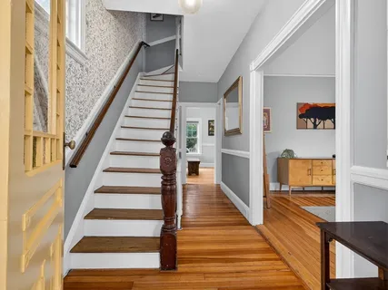 a view of entryway and hall with wooden floor