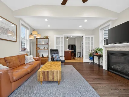 a living room with fireplace furniture and a flat screen tv