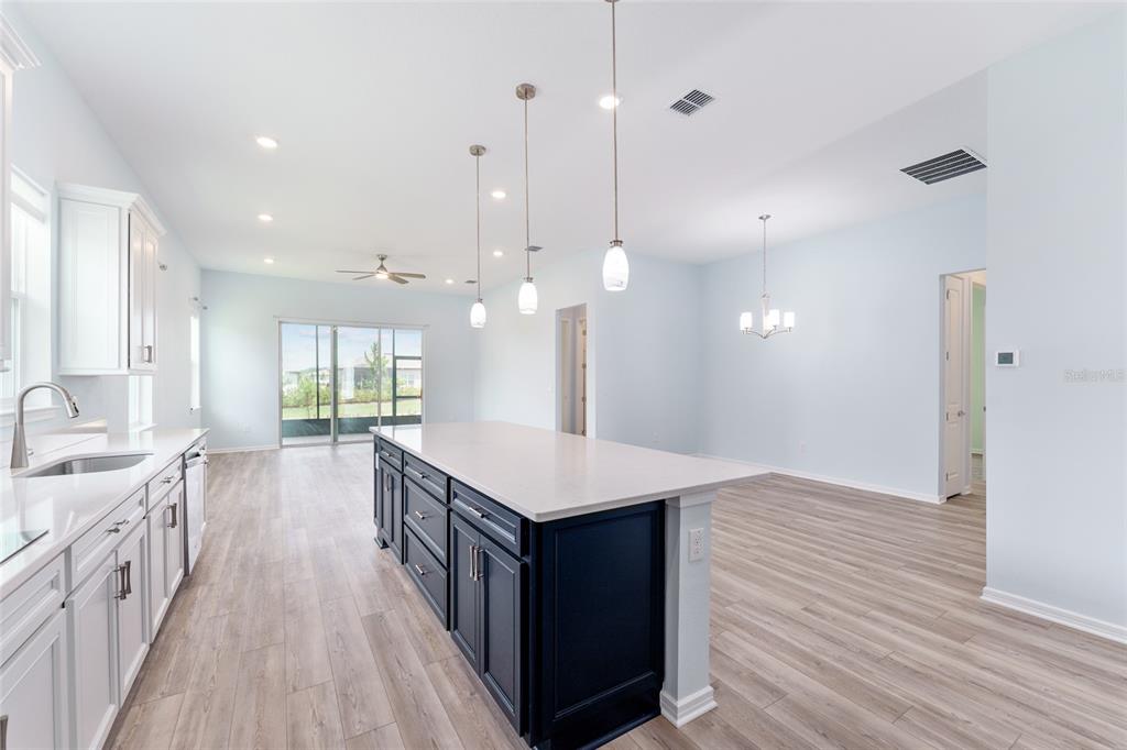 6023 Southwest 86th Circle Ocala, FL 34481 - Photo 15 of 55 a kitchen with a stove and a wooden floor