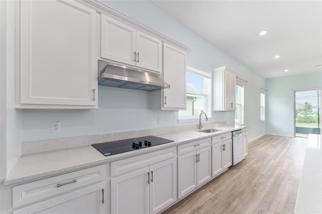 6023 Southwest 86th Circle Ocala, FL 34481 - Photo 16 of 55 a kitchen with white cabinets and sink