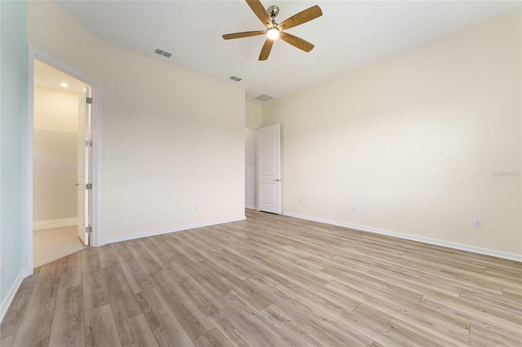 6023 Southwest 86th Circle Ocala, FL 34481 - Photo 22 of 55 an empty room with wooden floor and windows