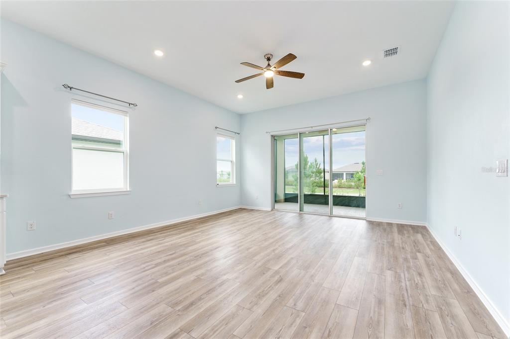 6023 Southwest 86th Circle Ocala, FL 34481 - Photo 6 of 55 a view of an empty room with wooden floor and a window