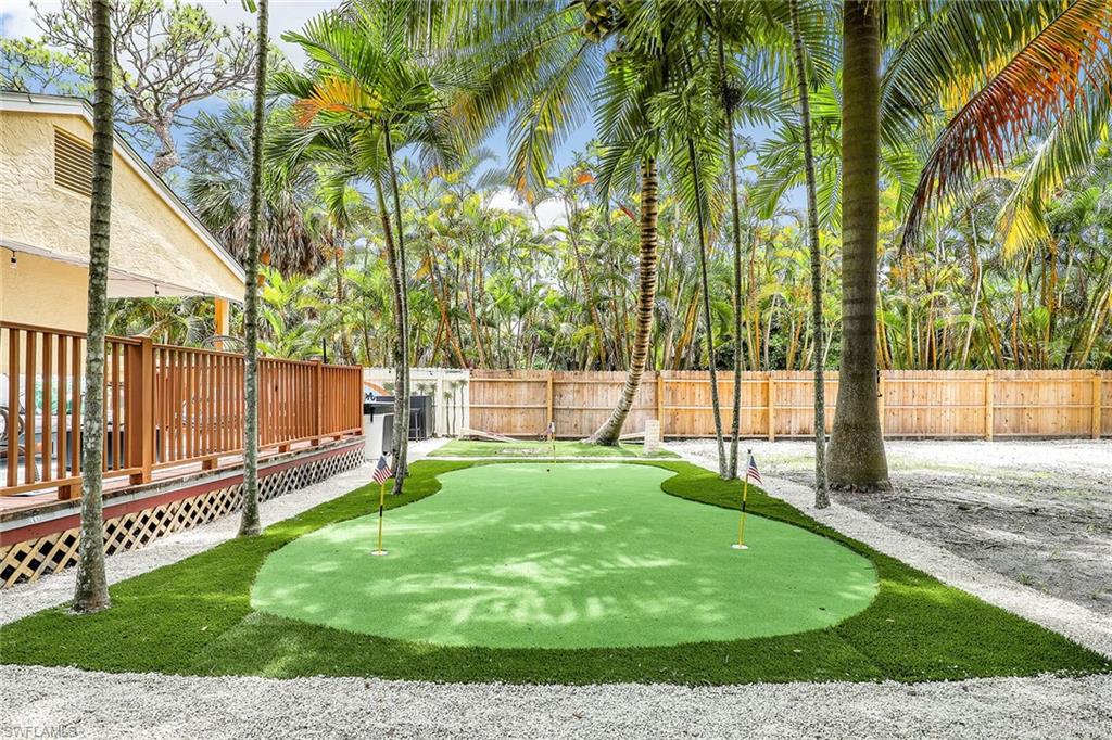 2780 Weeks Avenue Naples, FL 34112 - Photo 20 of 34 a view of a backyard with a garden and trees