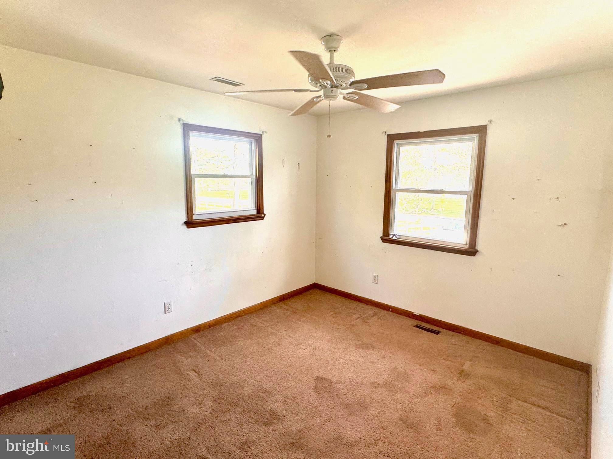 124 Buddtown Road Southampton, NJ 08088 - Photo 16 of 45 an empty room with a window and a fan