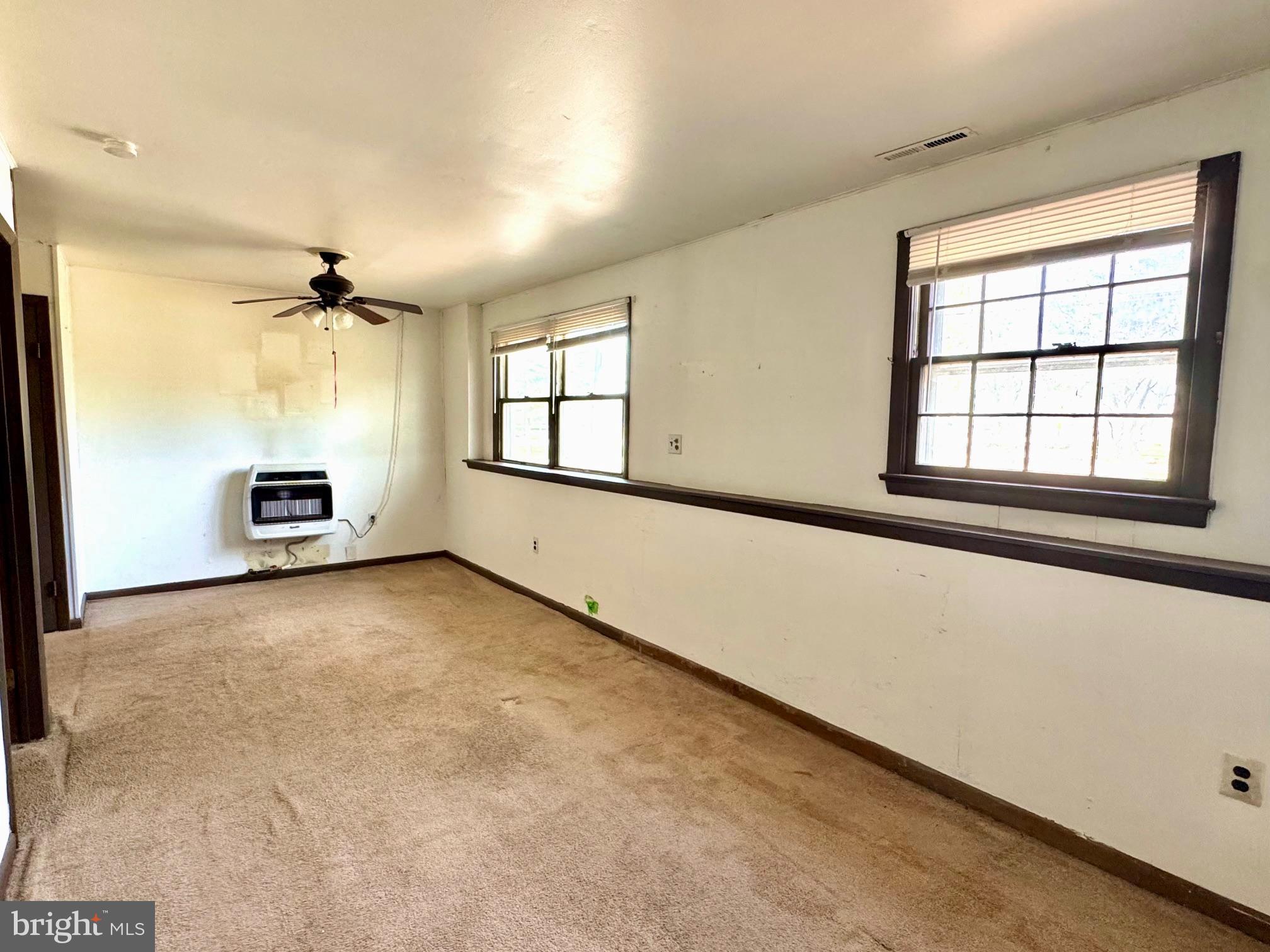 124 Buddtown Road Southampton, NJ 08088 - Photo 36 of 45 an empty room with windows and ceiling fan