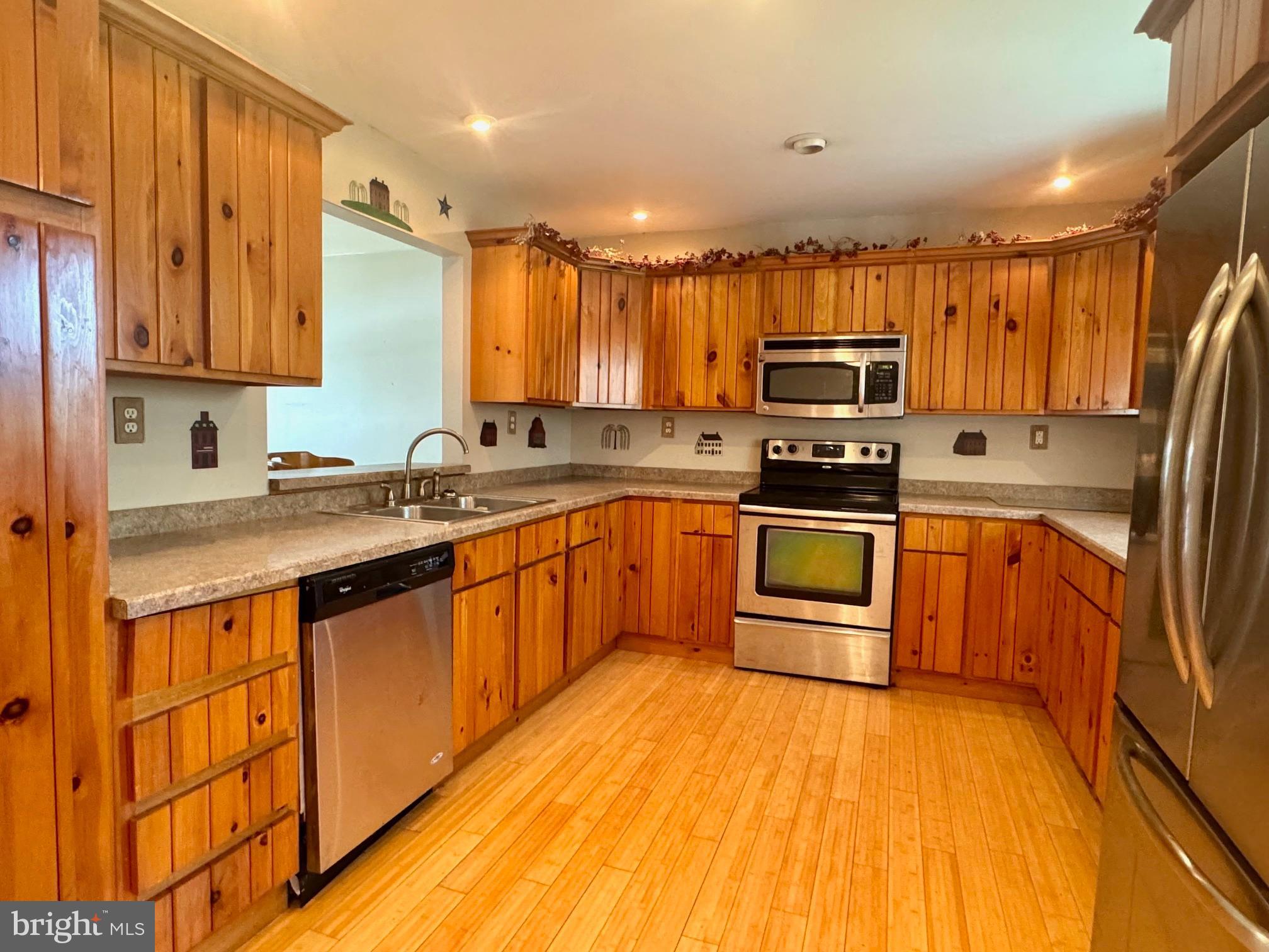 124 Buddtown Road Southampton, NJ 08088 - Photo 7 of 45 a kitchen with stainless steel appliances a sink cabinets and a wooden floor