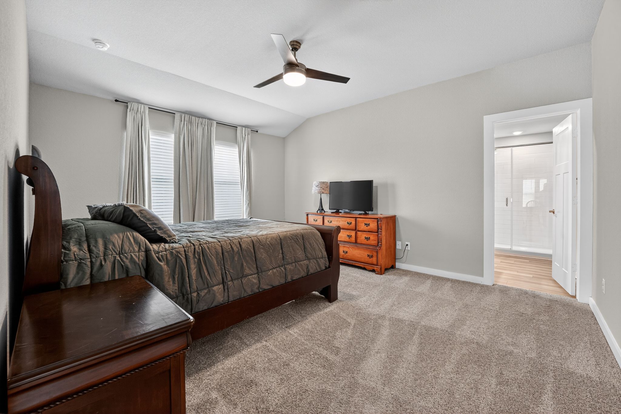 117 Halford Road Georgetown, TX 78633 - Photo 17 of 31 Bedroom with light colored carpet, a ceiling fan, and lofted ceiling