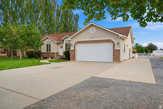 791 East Saddle Road Grantsville, UT 84029 - Photo 2 of 46 Stucco exterior with brick accents and an attached garage with RV Parking.