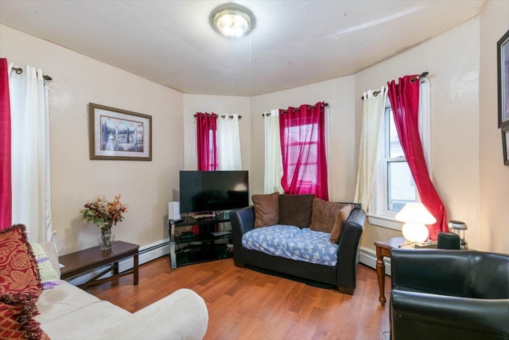 2 Washington Street Lawrence, MA 01841 - Photo 11 of 28 a living room with furniture and a flat screen tv