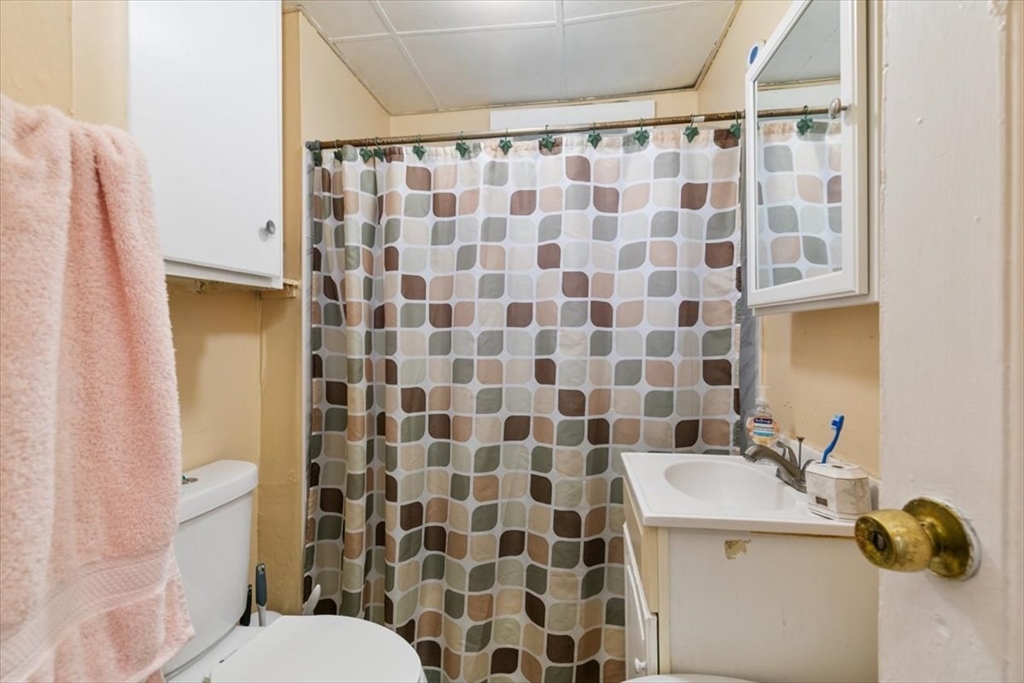 2 Washington Street Lawrence, MA 01841 - Photo 13 of 28 a bathroom with a sink toilet and shower
