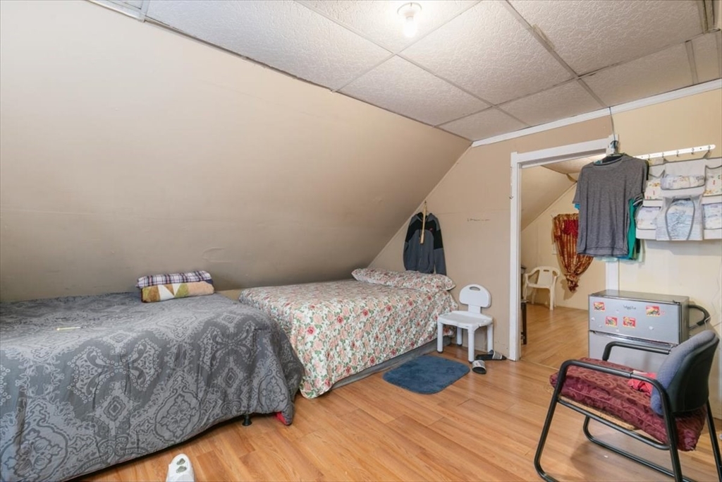 2 Washington Street Lawrence, MA 01841 - Photo 18 of 28 a bedroom with a bed and wooden floor