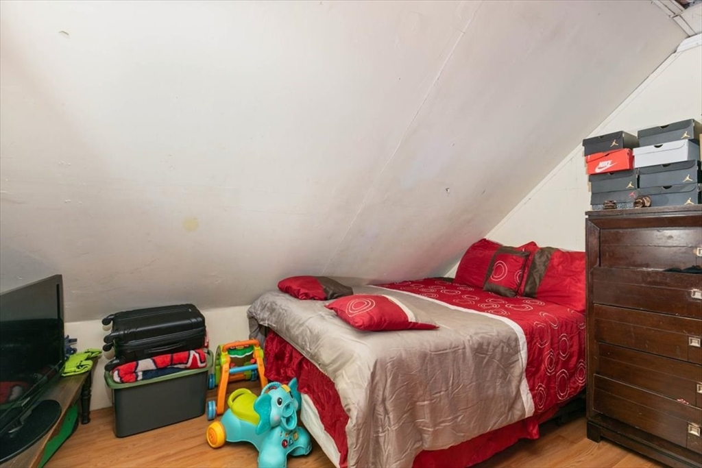 2 Washington Street Lawrence, MA 01841 - Photo 21 of 28 a bedroom with a bed and a tv in it