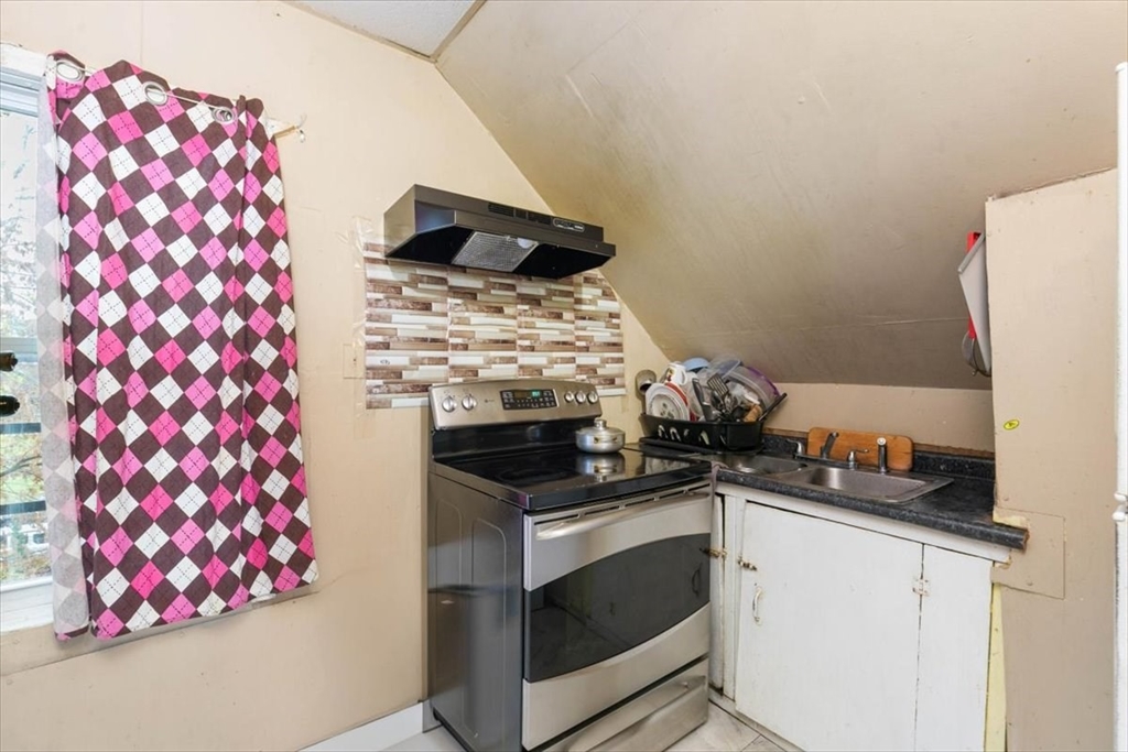 2 Washington Street Lawrence, MA 01841 - Photo 23 of 28 a kitchen with granite countertop a stove and a sink