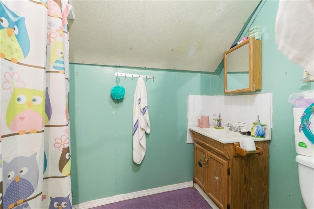 2 Washington Street Lawrence, MA 01841 - Photo 24 of 28 a bathroom with a sink a mirror and shower