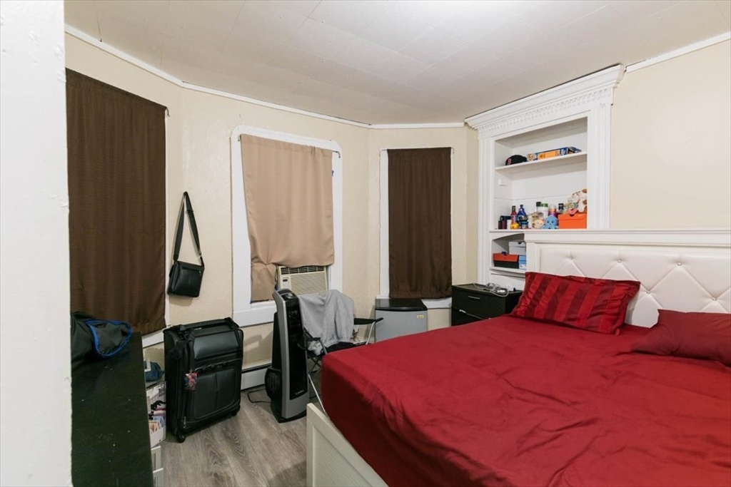 2 Washington Street Lawrence, MA 01841 - Photo 7 of 28 a bedroom with a large bed and a closet