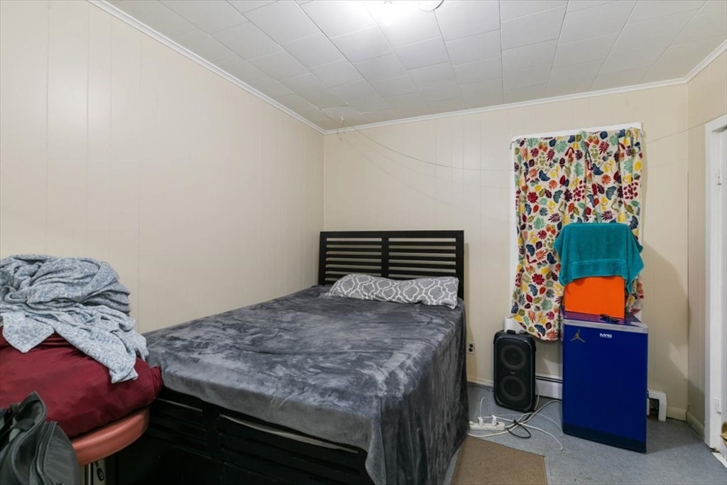 2 Washington Street Lawrence, MA 01841 - Photo 8 of 28 a bedroom with a bed and a window