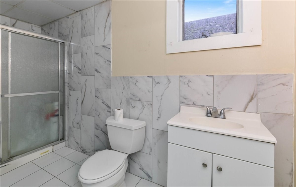 2 Washington Street Lawrence, MA 01841 - Photo 9 of 28 a bathroom with a sink toilet and shower