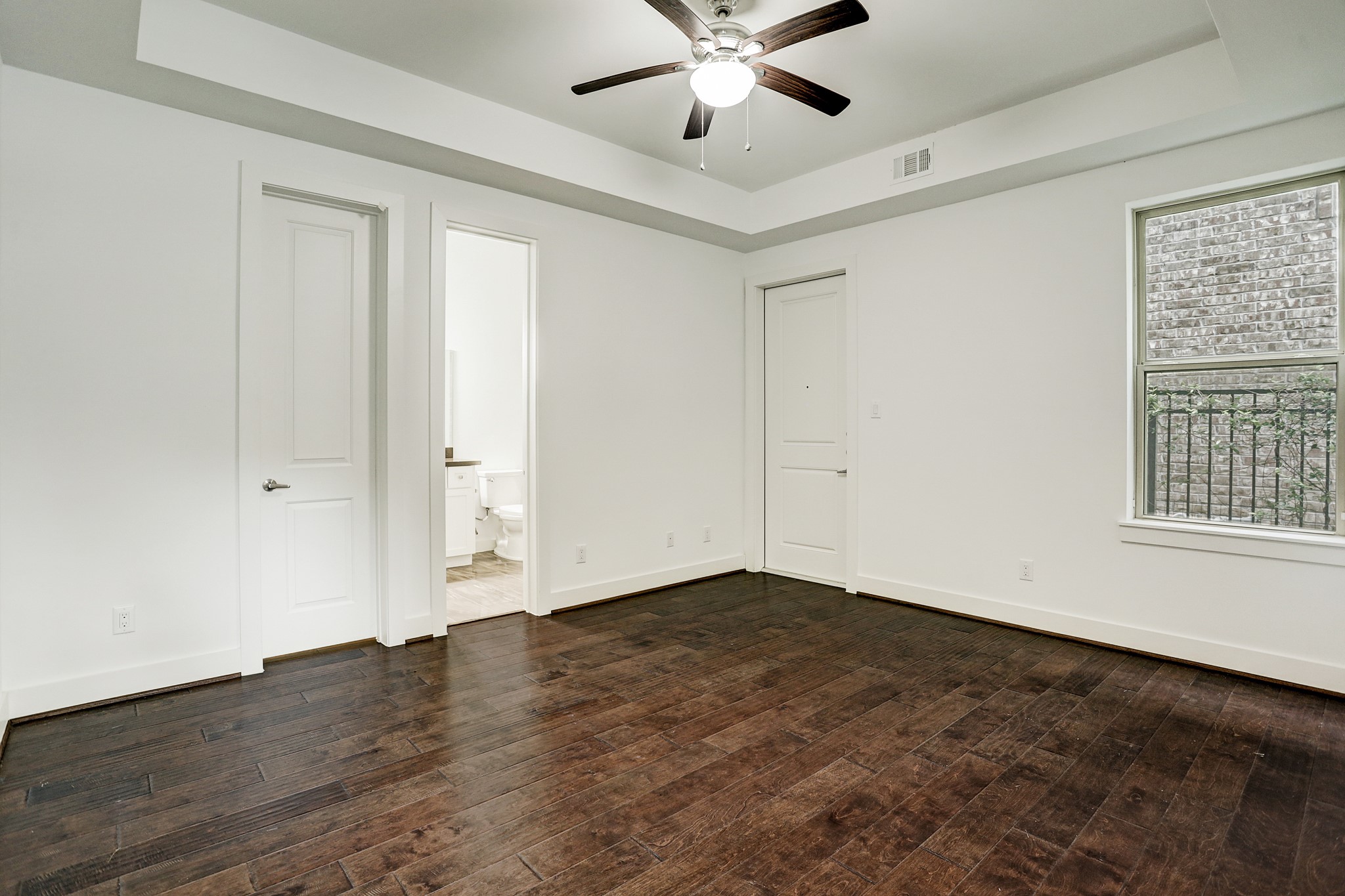 1402 Eberhard Street Houston, TX 77019 - Photo 10 of 50 a view of an empty room with wooden floor and a window