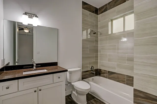 a living room with furniture a rug and a flat screen tv
