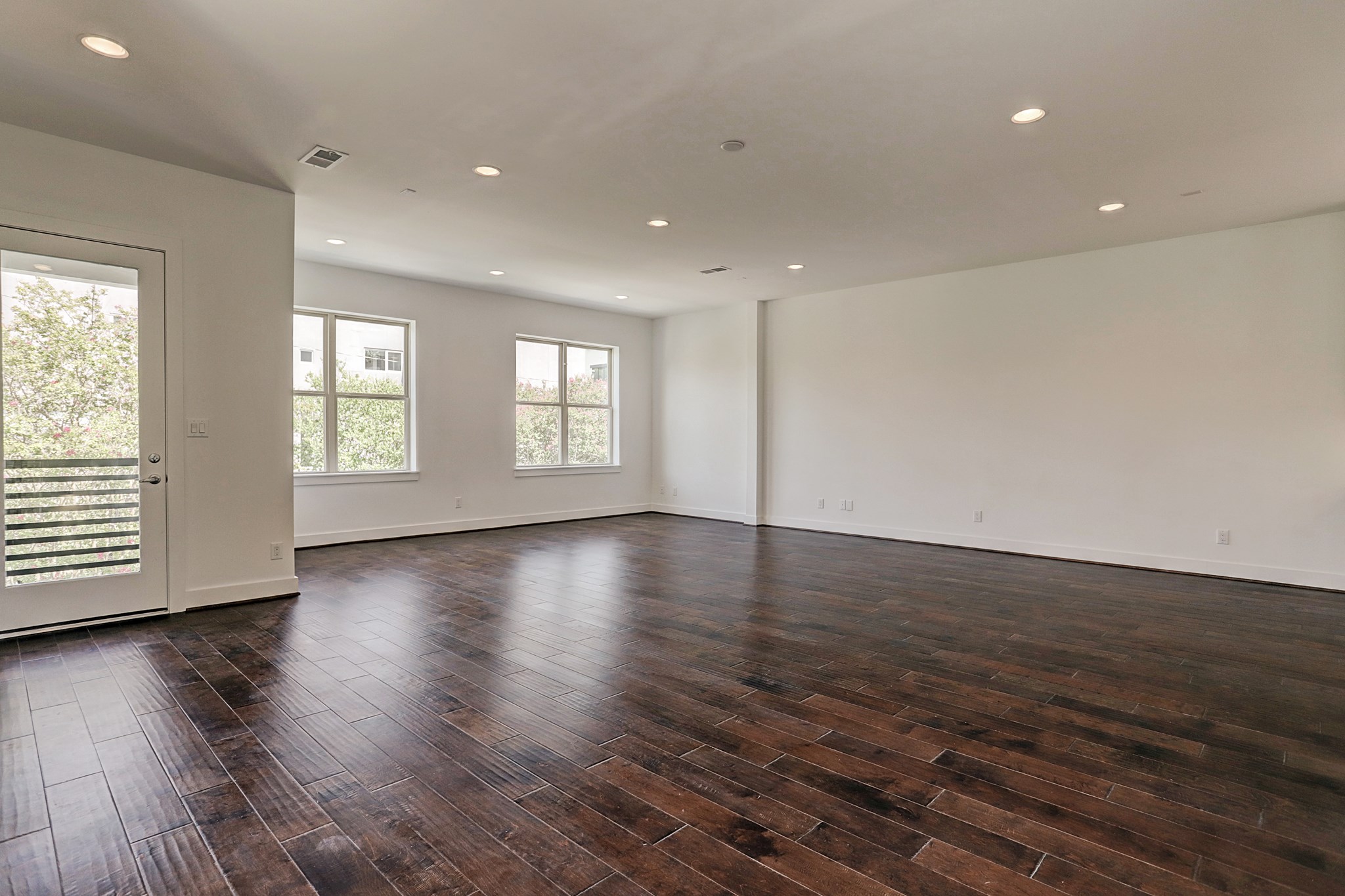 1402 Eberhard Street Houston, TX 77019 - Photo 15 of 50 an empty room with wooden floor and windows