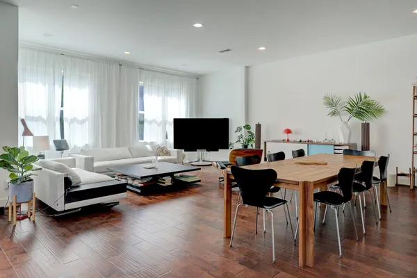 a living room with furniture flat screen tv and a large window