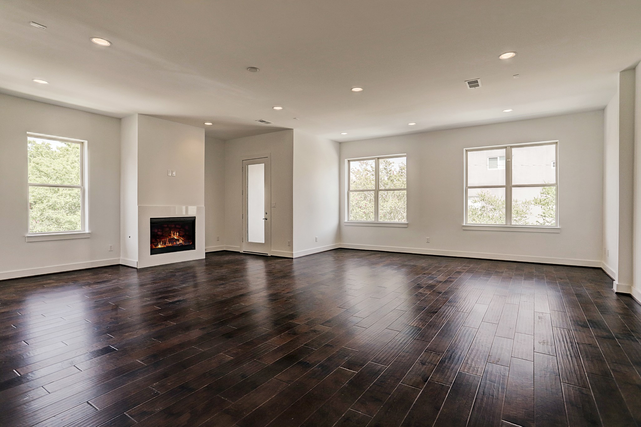 1402 Eberhard Street Houston, TX 77019 - Photo 18 of 50 an empty room with wooden floor and windows