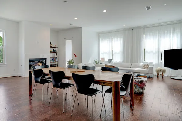 a view of a dining room with furniture and wooden floor
