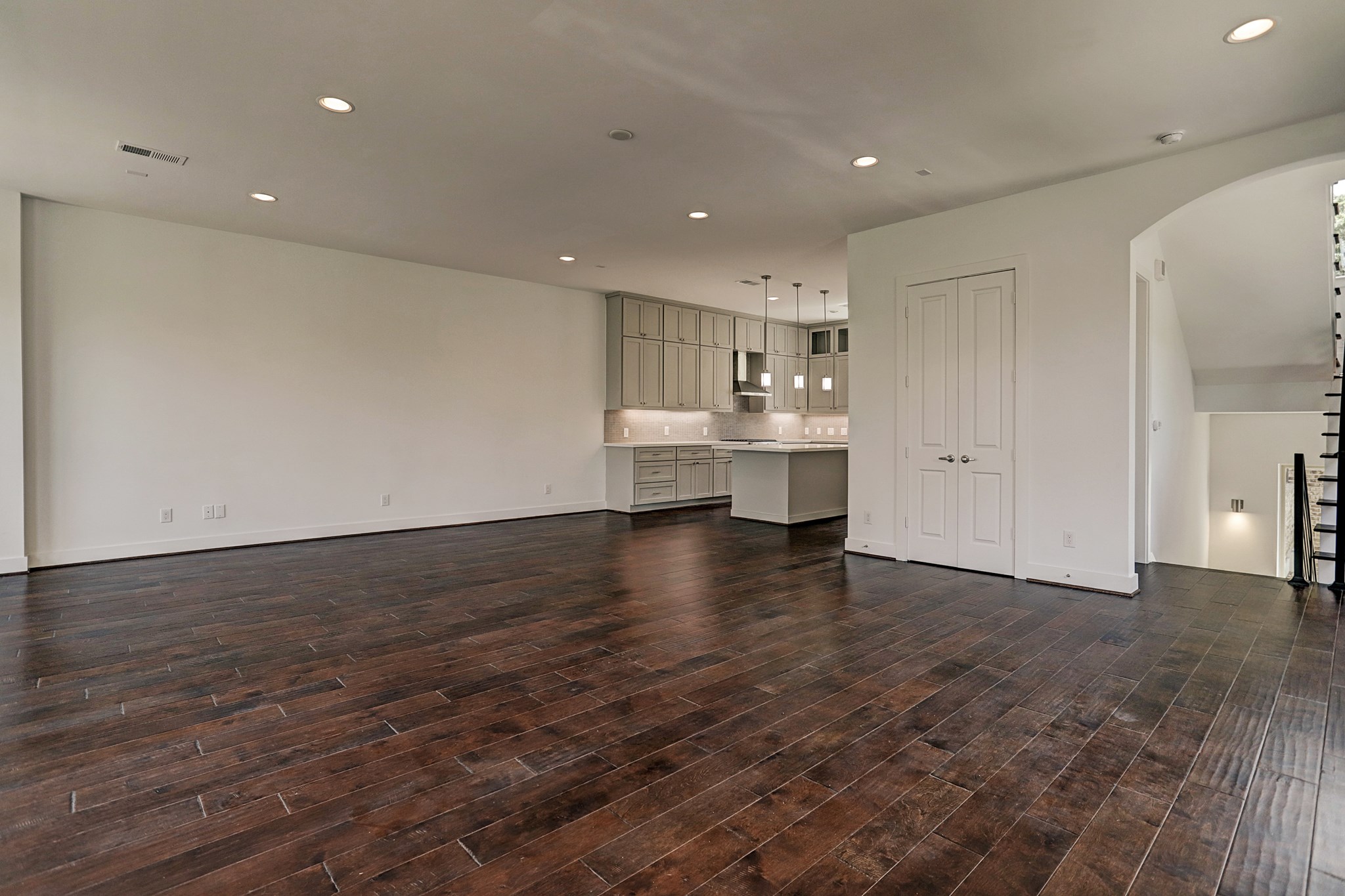1402 Eberhard Street Houston, TX 77019 - Photo 23 of 50 a view of kitchen and empty room with wooden floor