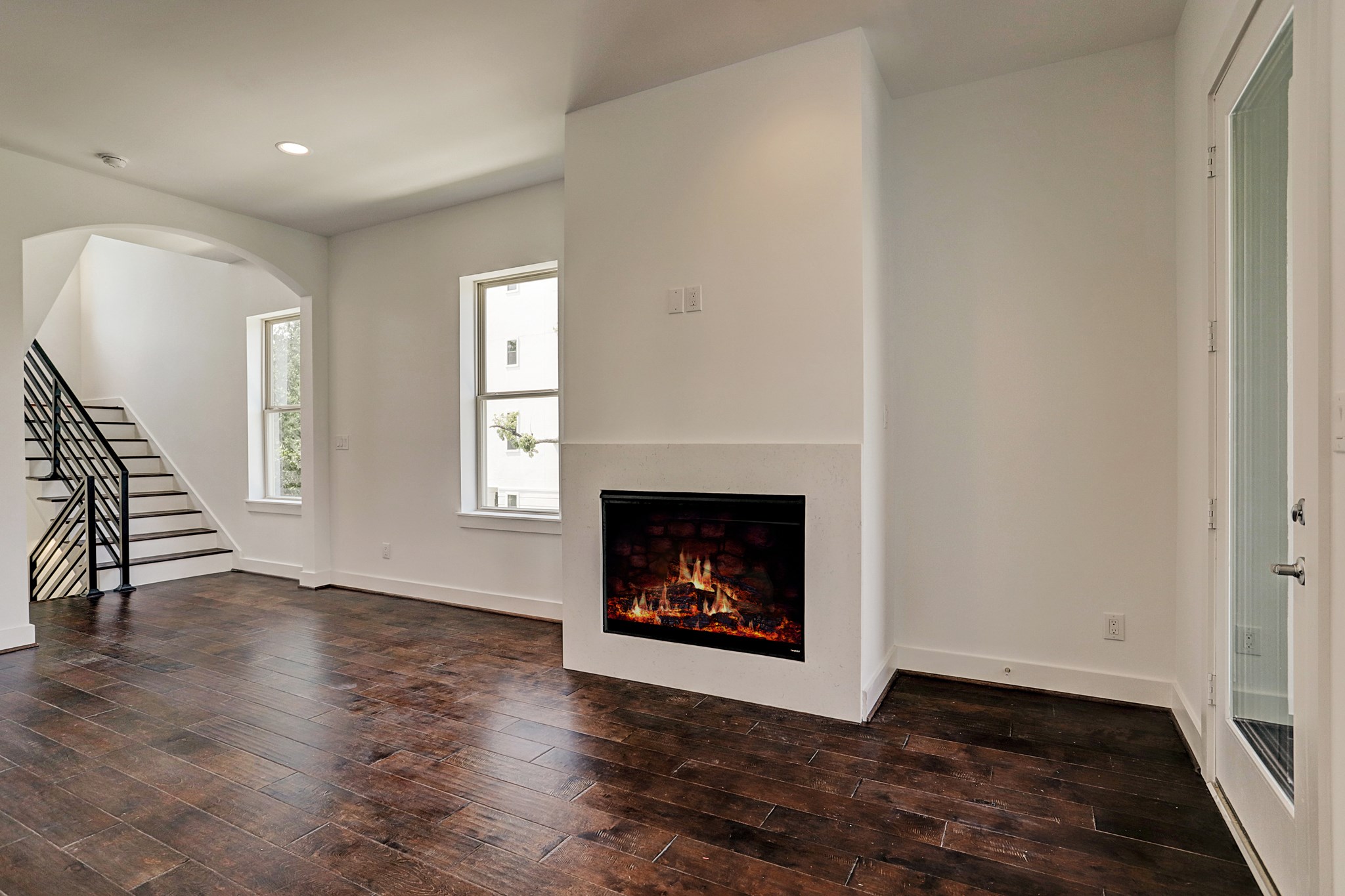 1402 Eberhard Street Houston, TX 77019 - Photo 24 of 50 a view of an empty room with wooden floor fireplace and a window