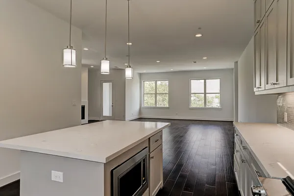 a kitchen with stainless steel appliances a sink stove and cabinets