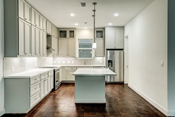 a kitchen with a sink stove and refrigerator