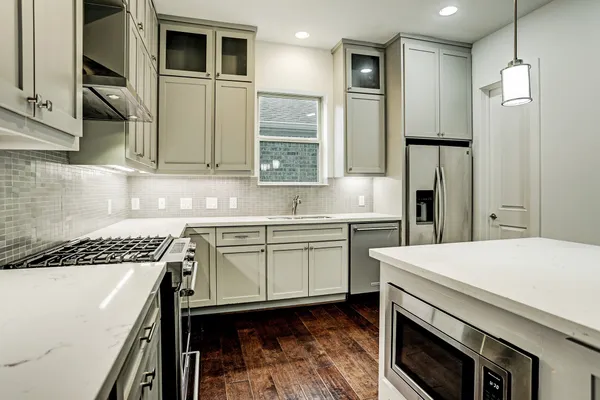 a kitchen with a sink appliances and cabinets