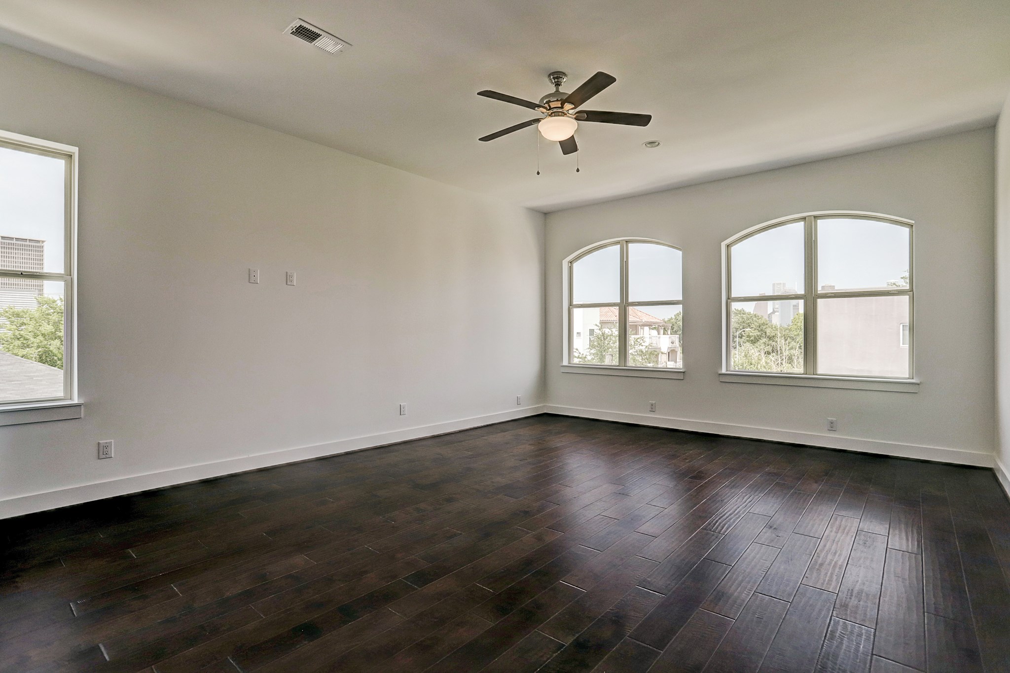 1402 Eberhard Street Houston, TX 77019 - Photo 33 of 50 a view of an empty room with wooden floor and a window