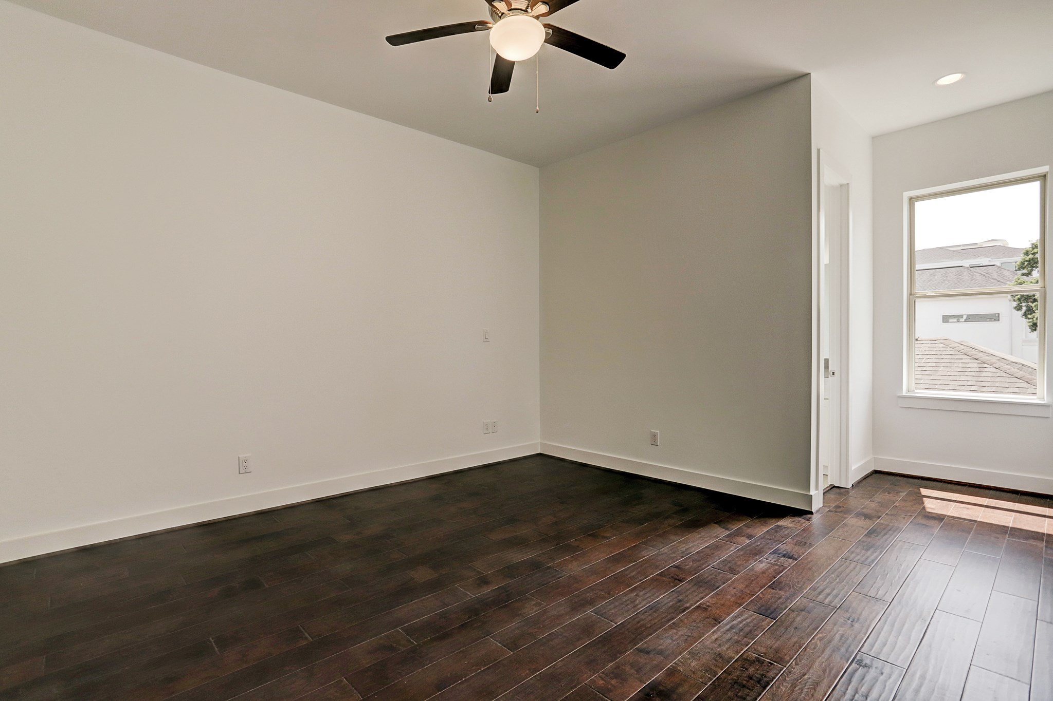 1402 Eberhard Street Houston, TX 77019 - Photo 38 of 50 an empty room with wooden floor chandelier fan and windows