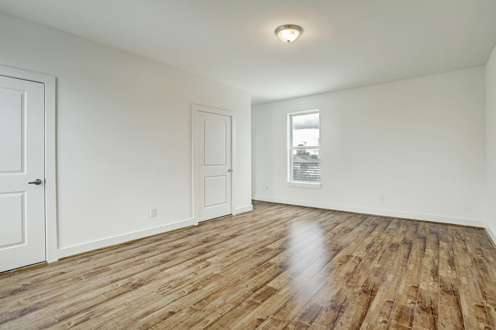 1402 Eberhard Street Houston, TX 77019 - Photo 45 of 50 an empty room with wooden floor and windows