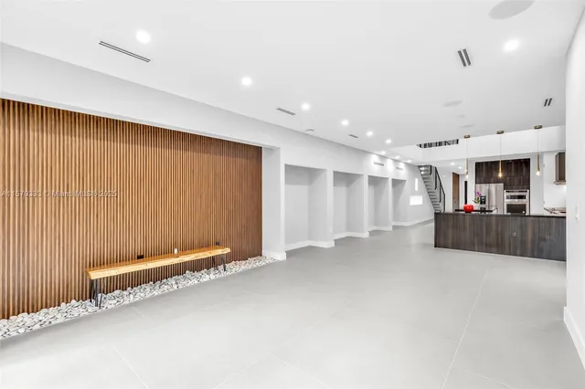 a living room with furniture and a kitchen