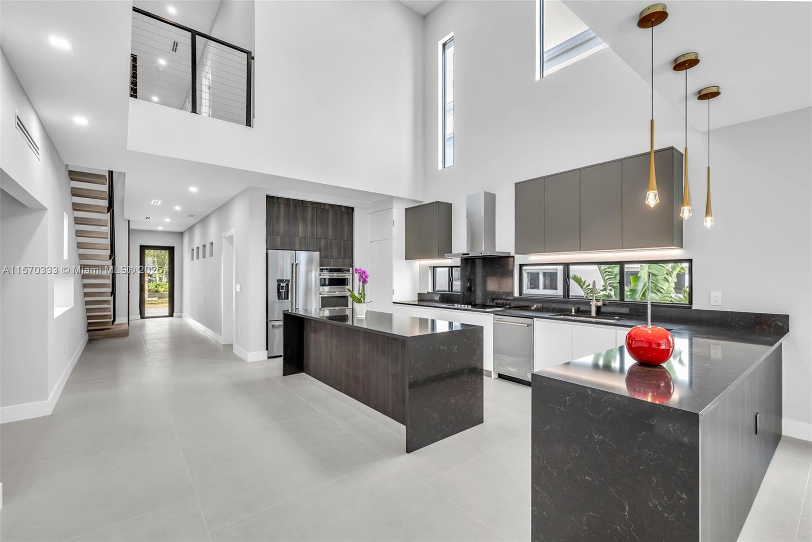 808 Southwest 9th Street, Unit 808A Fort Lauderdale, FL 33315 - Photo 2 of 30 a living room with stainless steel appliances kitchen island furniture and a flat screen tv