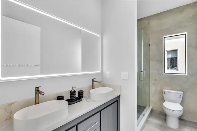a bathroom with a sink toilet tub and shower