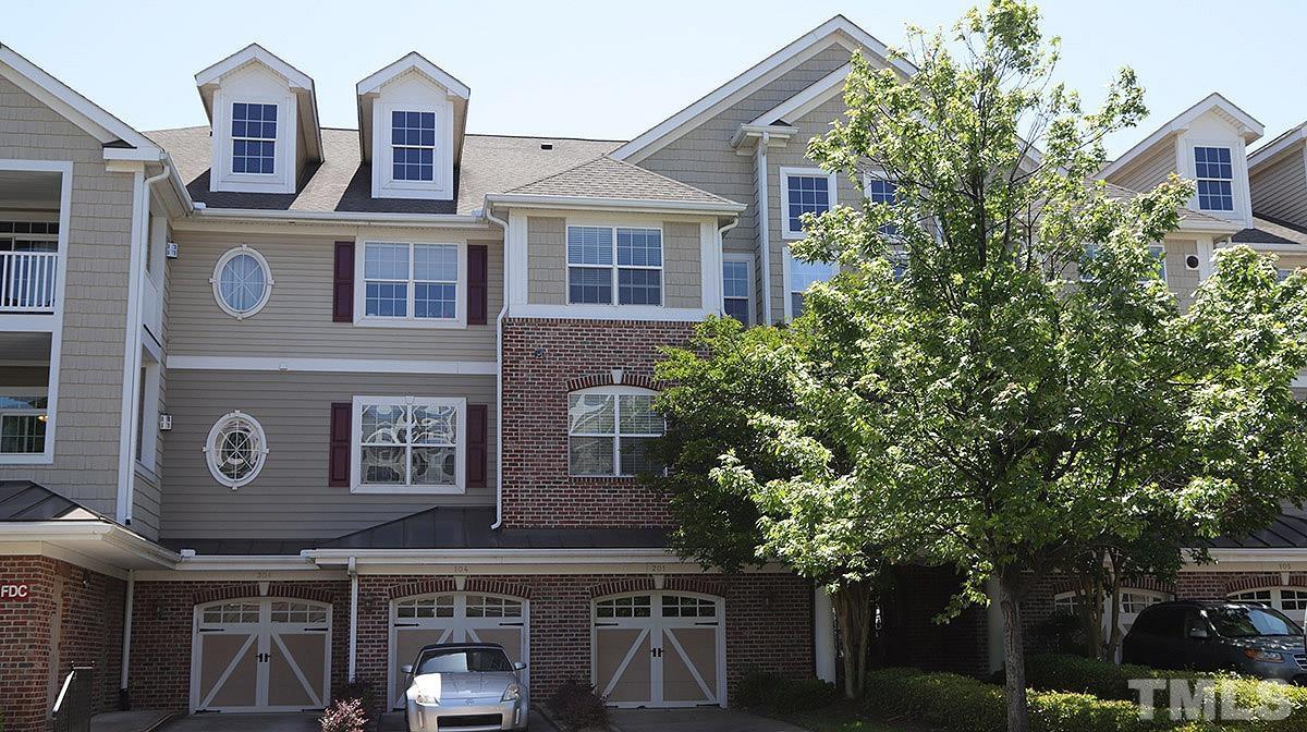 10411 Rosegate Court, Unit 202 Raleigh, NC 27617 - Photo 1 of 35 a front view of a building with trees