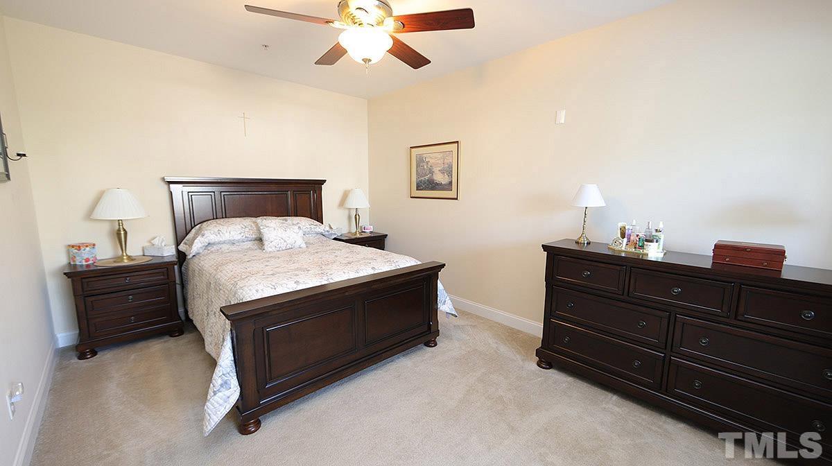 10411 Rosegate Court, Unit 202 Raleigh, NC 27617 - Photo 19 of 35 a room with a bed and a chandelier