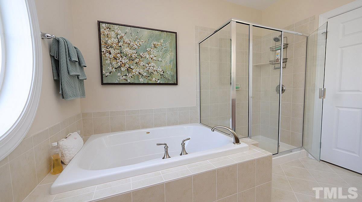 10411 Rosegate Court, Unit 202 Raleigh, NC 27617 - Photo 22 of 35 a bathroom with a bathtub and a shower