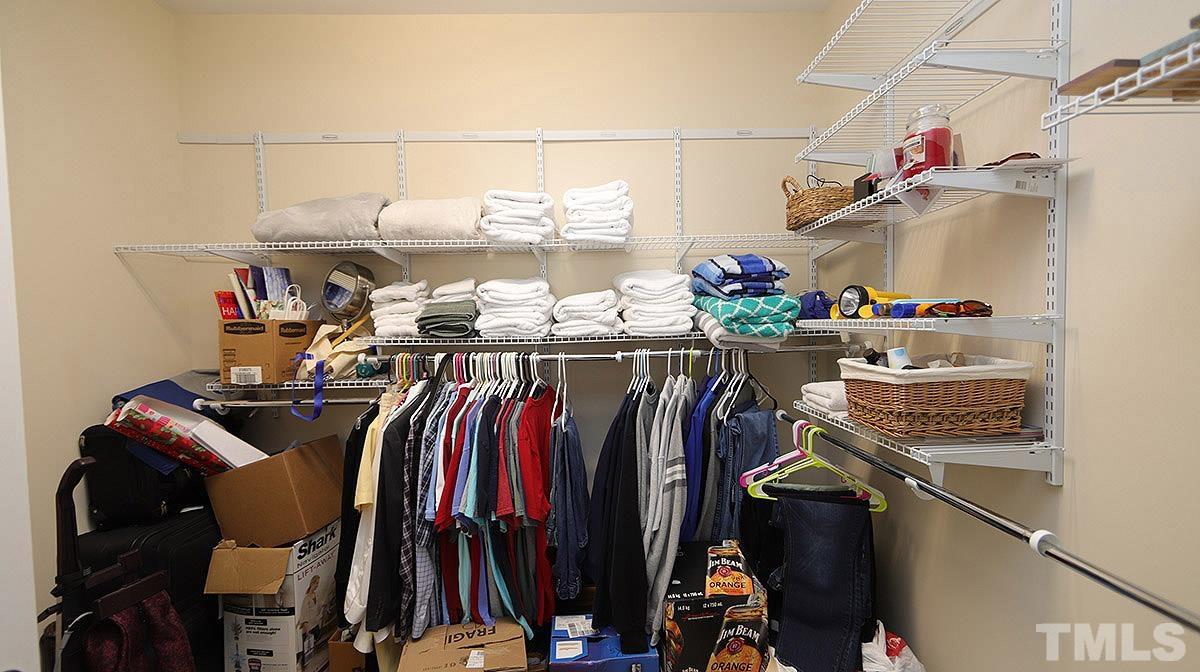 10411 Rosegate Court, Unit 202 Raleigh, NC 27617 - Photo 23 of 35 a view of walk in closet with clothes and shoes