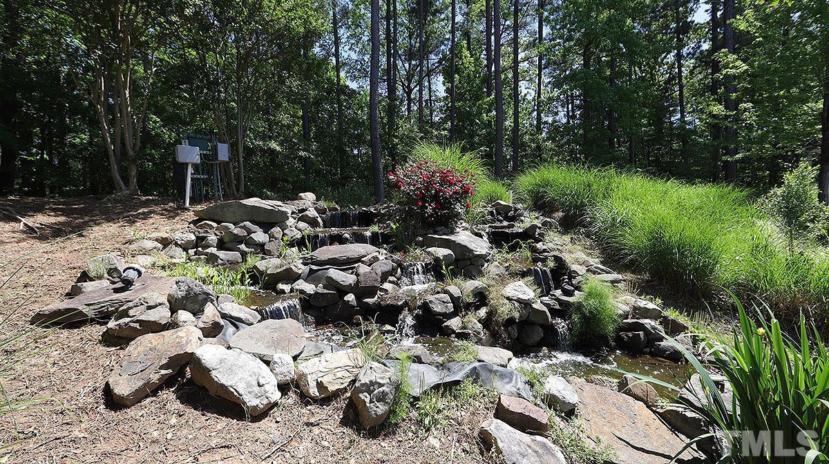 10411 Rosegate Court, Unit 202 Raleigh, NC 27617 - Photo 30 of 35 a garden with lots of trees and flowers