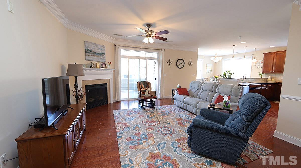 10411 Rosegate Court, Unit 202 Raleigh, NC 27617 - Photo 8 of 35 a living room with furniture a fireplace and a flat screen tv