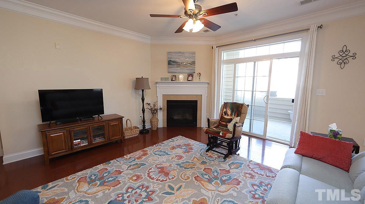 10411 Rosegate Court, Unit 202 Raleigh, NC 27617 - Photo 9 of 35 a living room with furniture and a flat screen tv