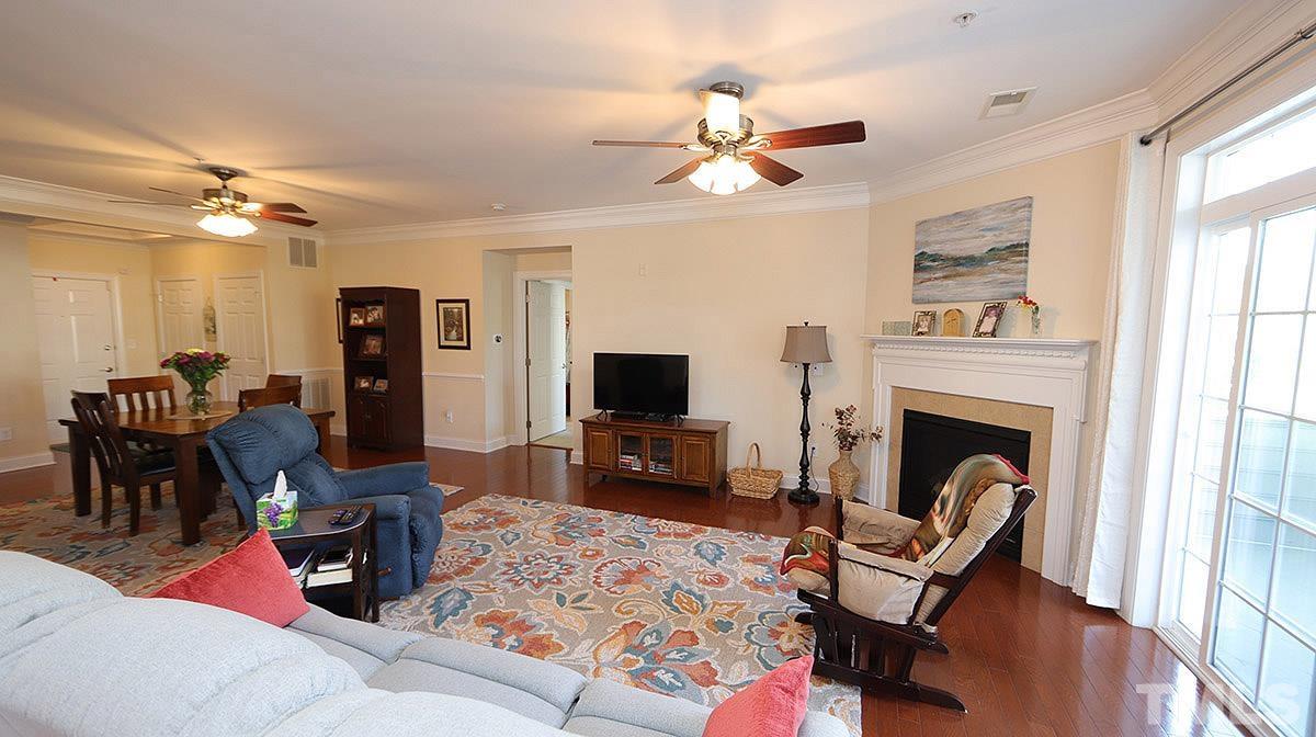10411 Rosegate Court, Unit 202 Raleigh, NC 27617 - Photo 10 of 35 a living room with furniture a fireplace and a flat screen tv